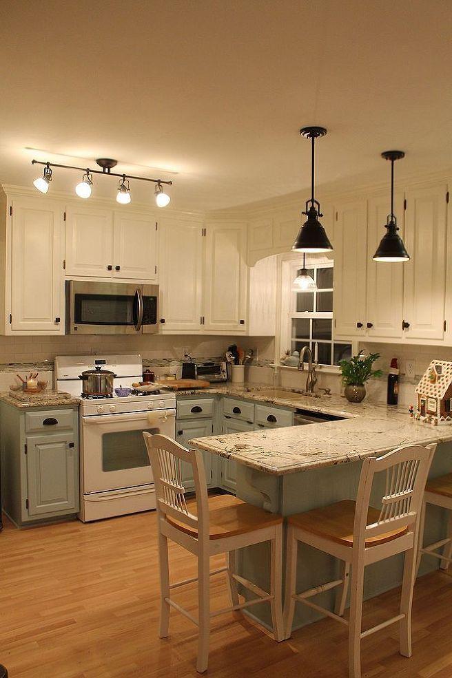 Marble topped kitchen counter with blue-grey cabinets and wooden floor