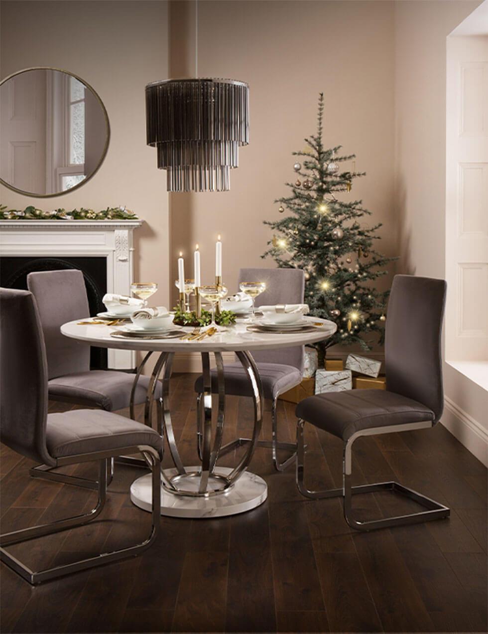 Chandelier above a white marble dining table in a glamorous Christmas setting.