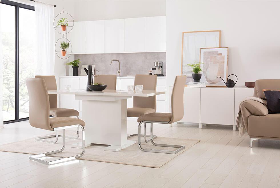 Glossy white dining table with matte dining chairs.