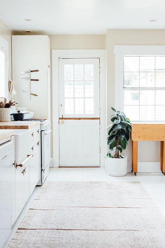 Tidy white kitchen interior with indoor plants