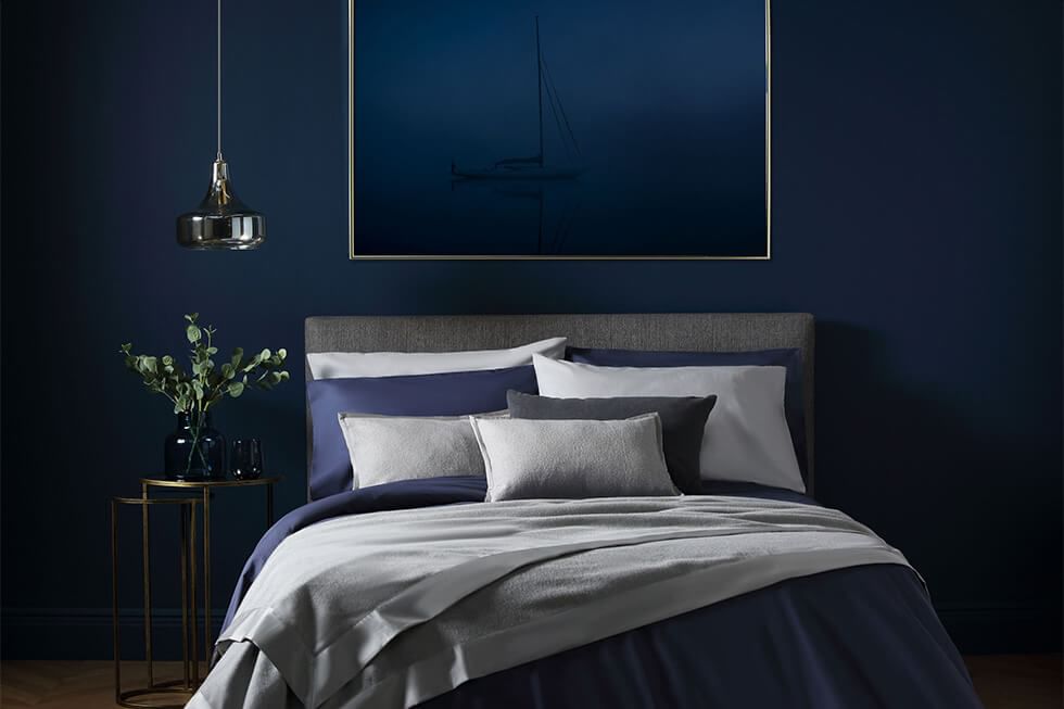 Black minimalist bedroom with ambient lighting