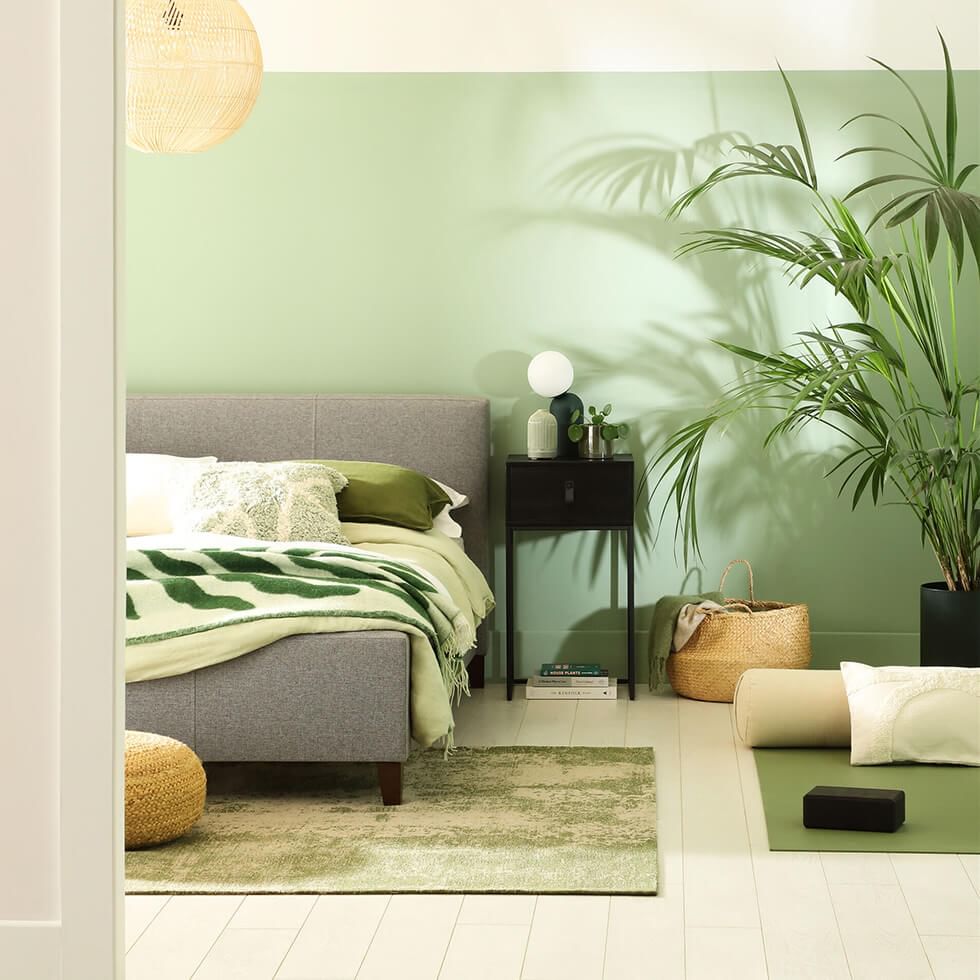 Green minimalist bedroom with bed close to the floor