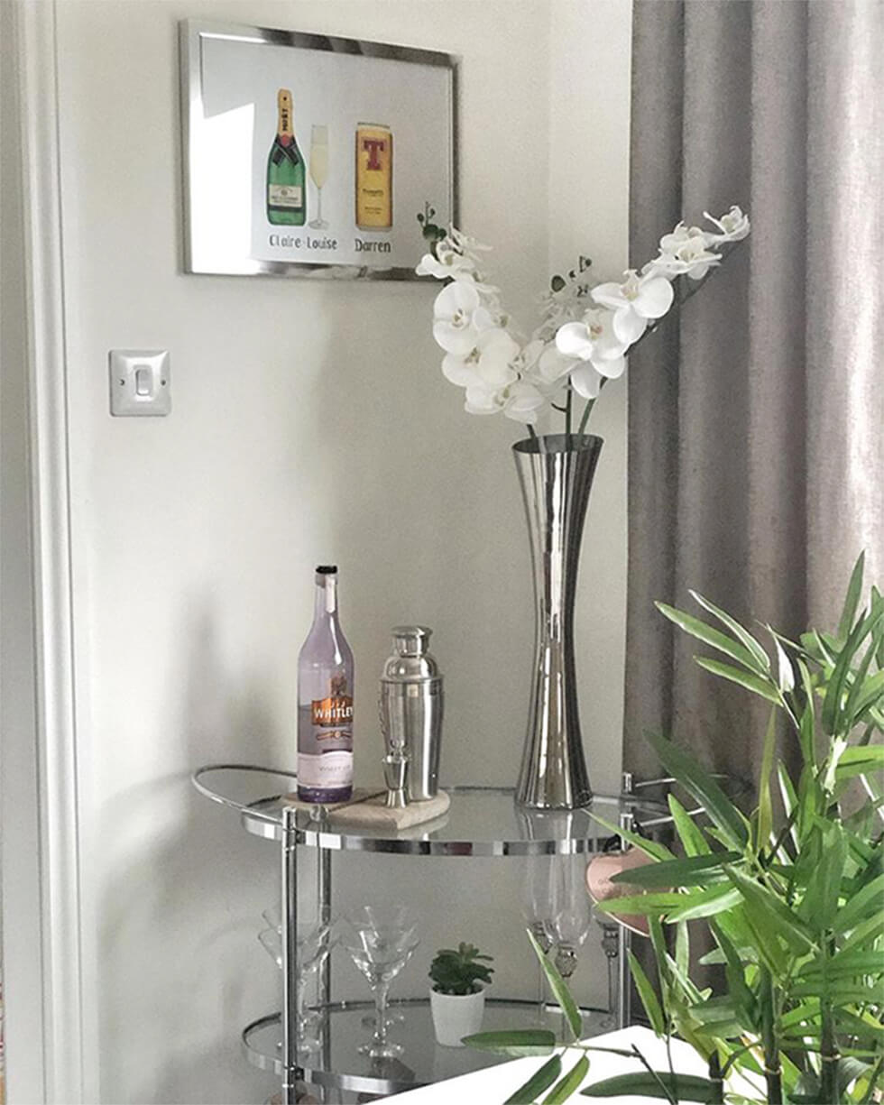 chrome and glass drinks trolley in a corner of the room