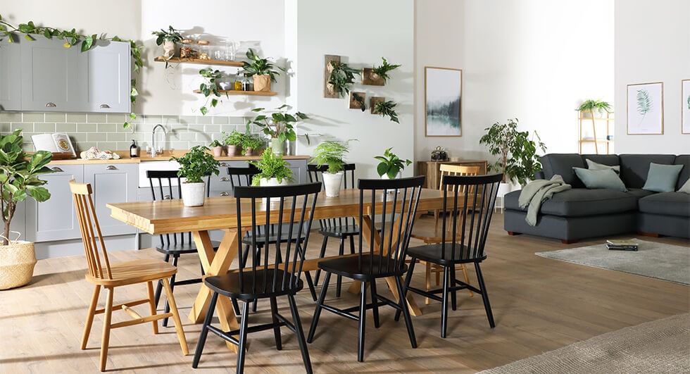 Wooden dining set and corner sofa in spacious open plan kitchen