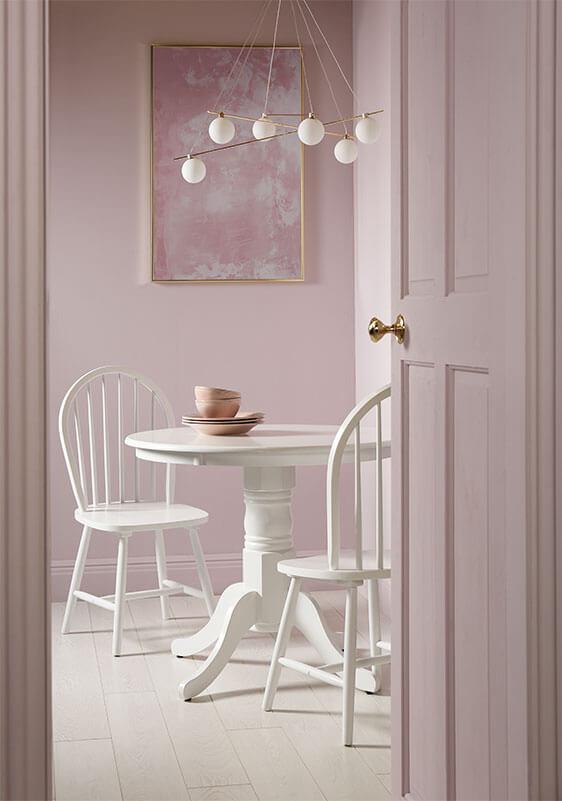 Light mauve room with white dining set.My Domaine, One Kings Lane