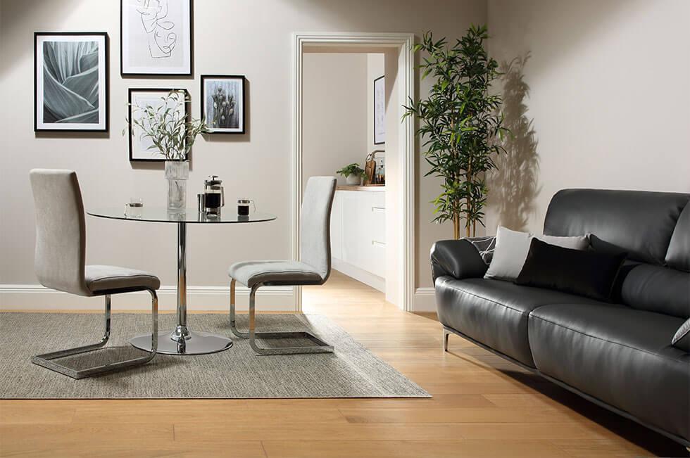 A small dining and living room space with a glass table.