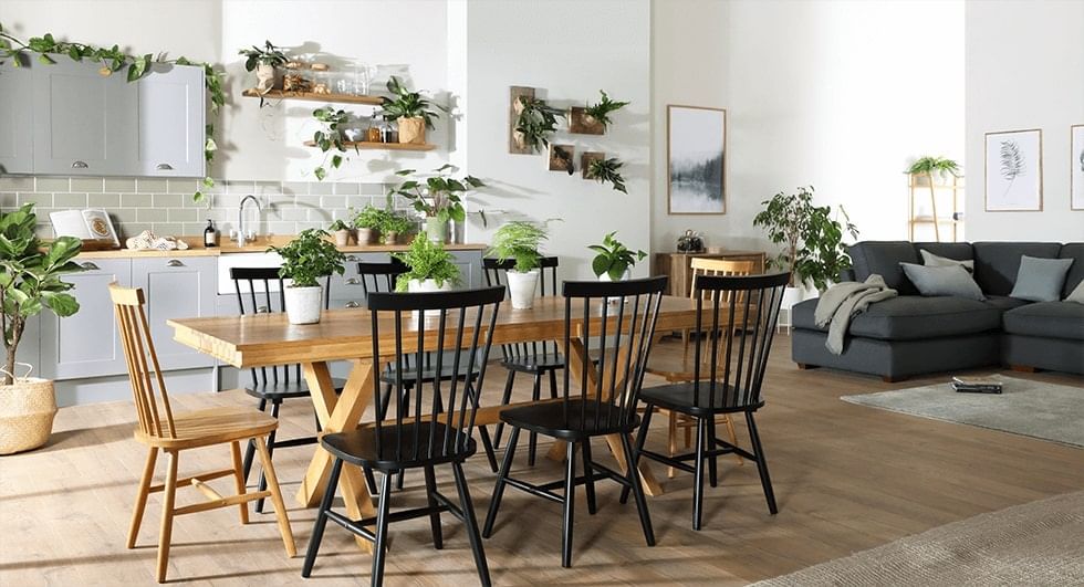 An oak dining set without a rug underneath, in an open plan living-dining space