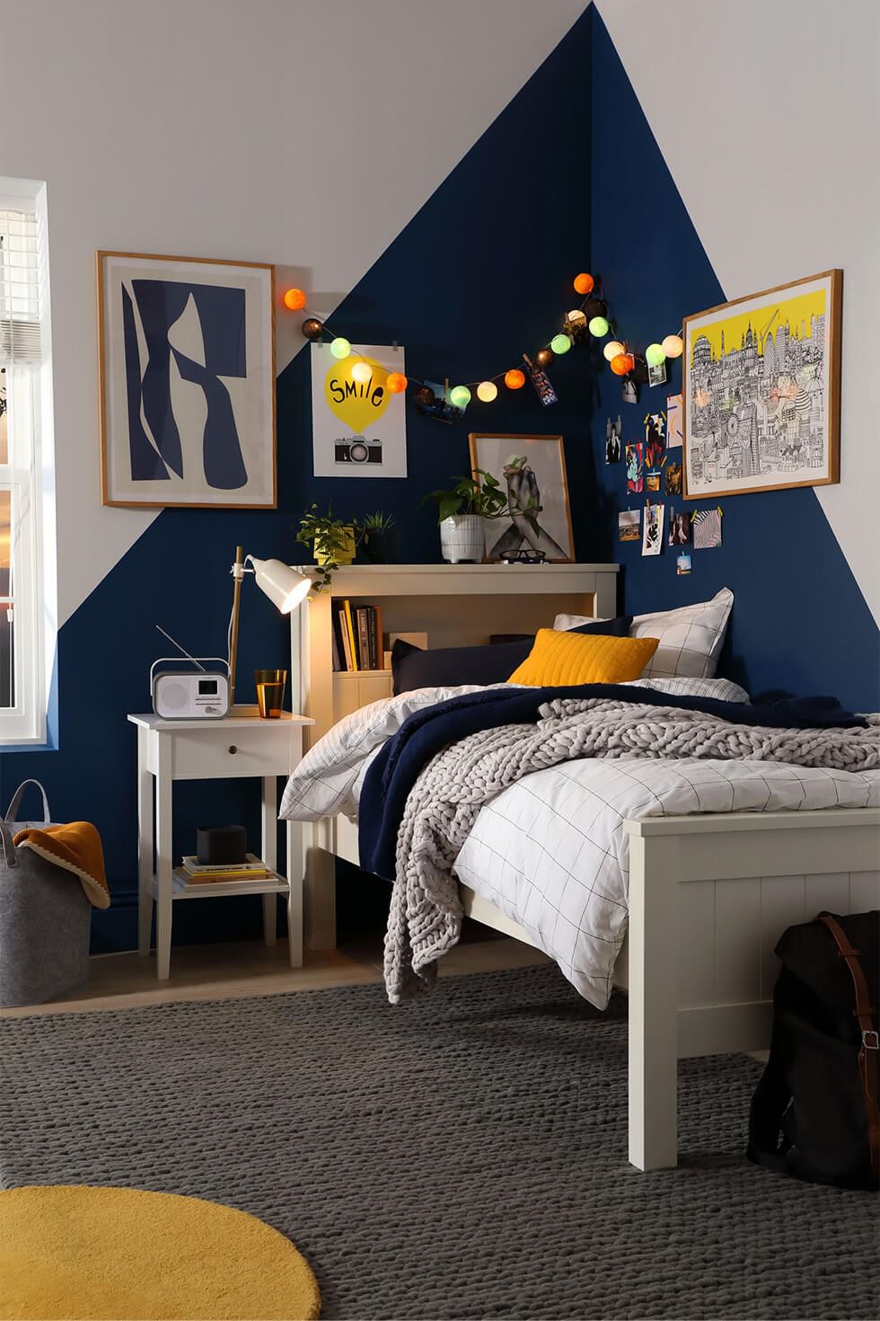 Boys corner of shared bedroom with bold feature wall and single bed