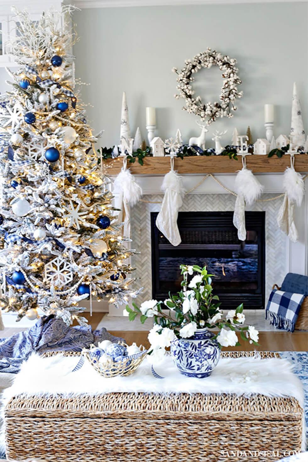 Living room with Christmas tree and stockings, tinsel and blue decor