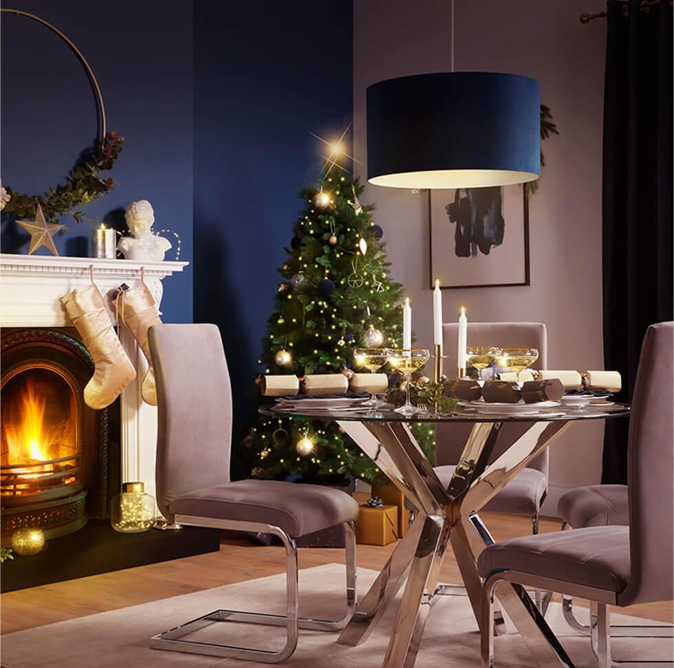 Blue Christmas dining room with chrome pedestal table and taupe chairs