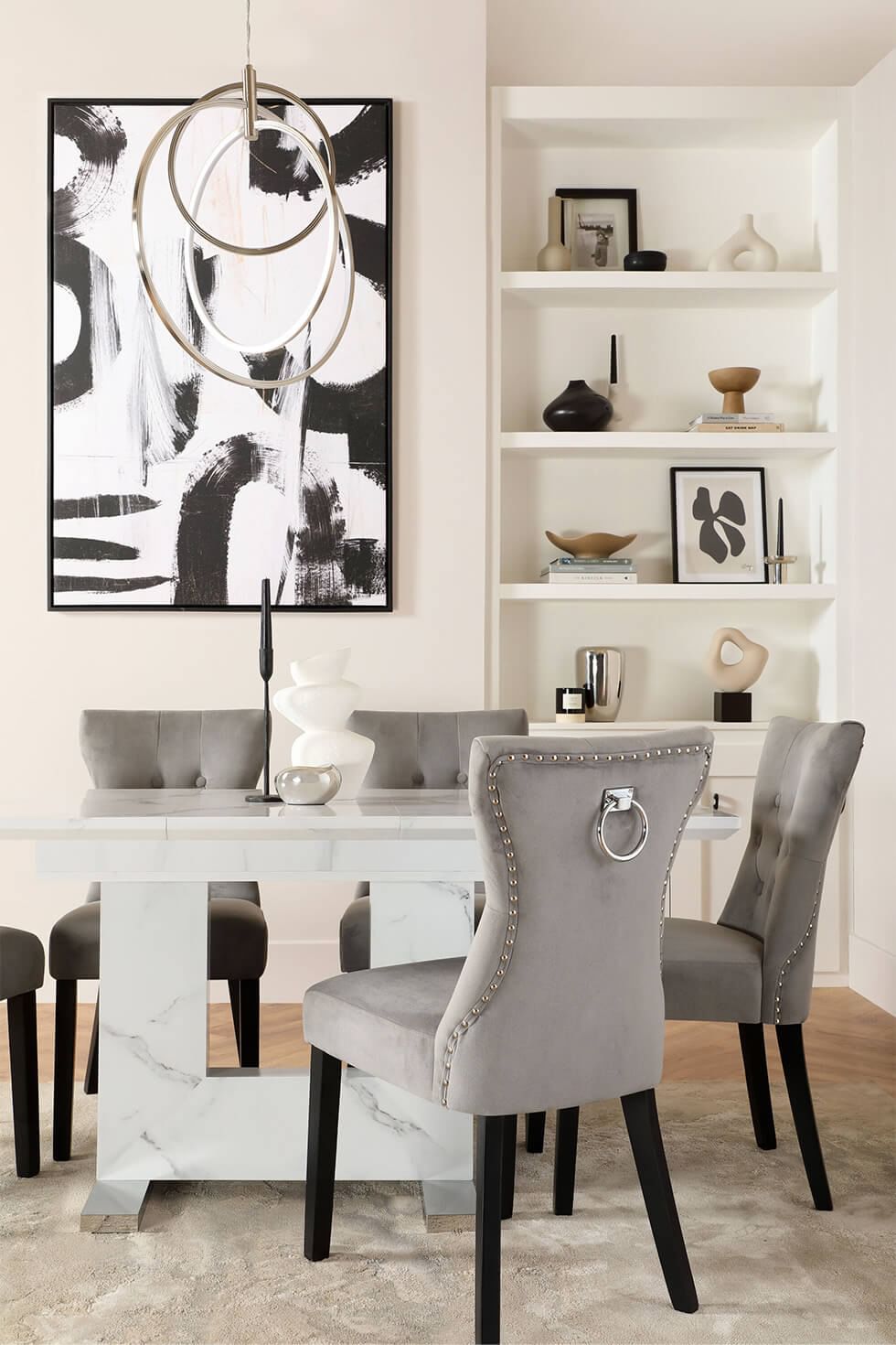 Marble effect dining table and velvet chairs in a monochrome dining room