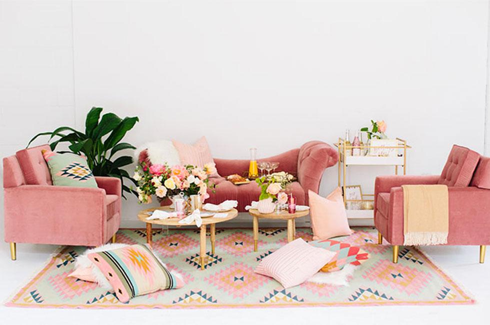 Pink sofas with assorted pastel decor. 