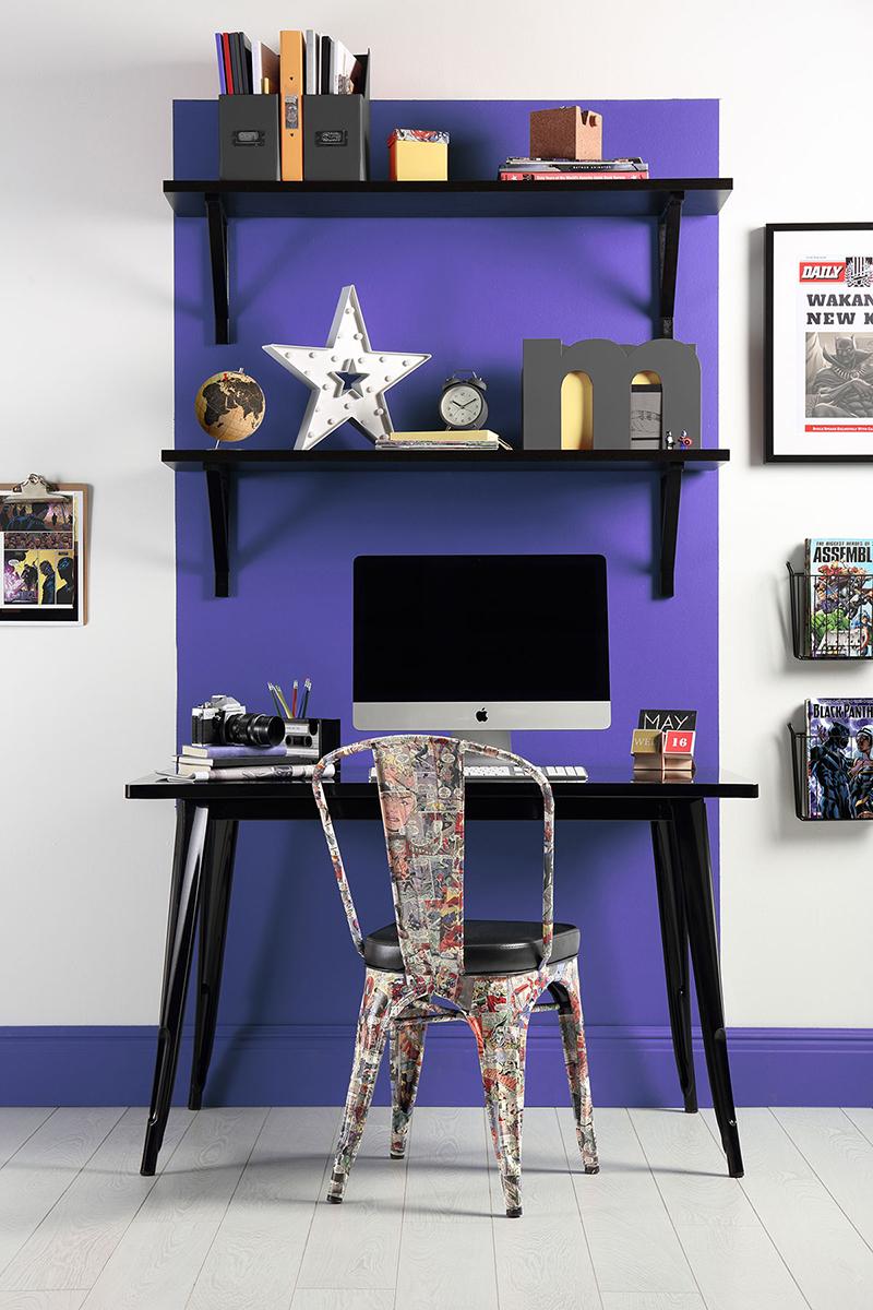 Study desk against a feature wall.