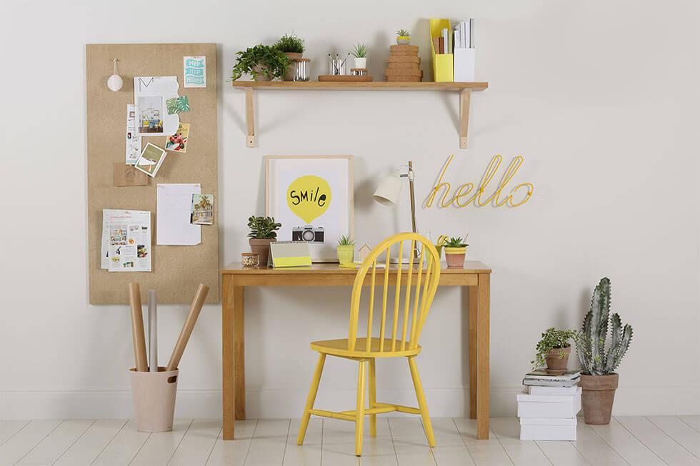 A neutral study space with a yellow chair.