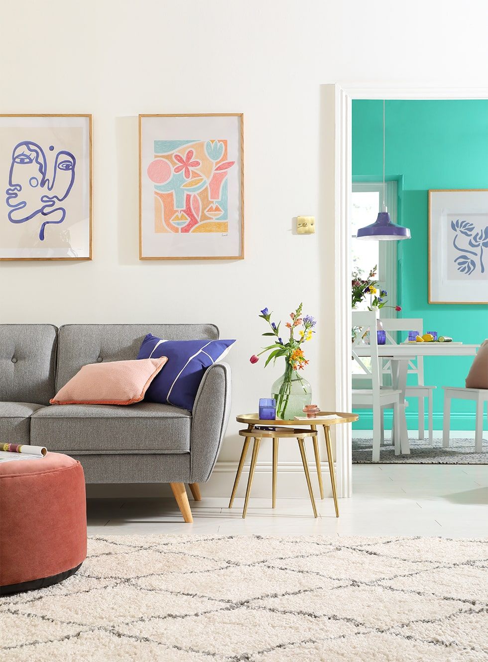 A Scandi inspired living room with a stylish grey sofa, and cushions and artwork in Pantone's Colour of the Year 2022 Very Peri.
