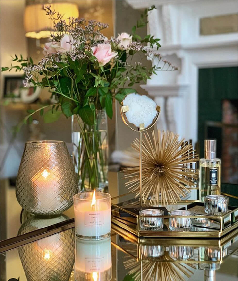 Coffee table in the living room with candles, ornaments and flowers