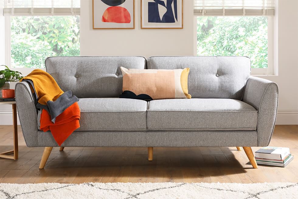 A stylish Scandi inspired sofa with button back detailing and solid hardwood legs