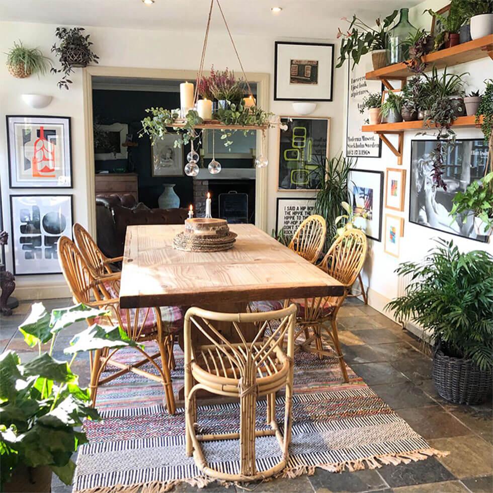 Eclectic dining room with indoor plants and wooden furniture