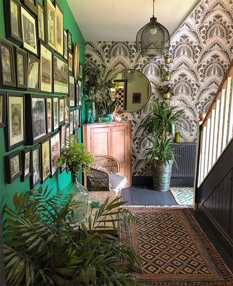 Green feature photo wall in the hallway with contrasting wallpaper