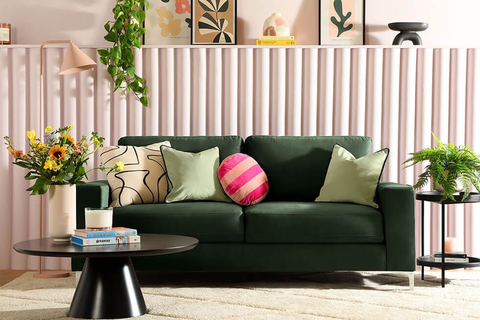 Green sofa in a pink and green living room