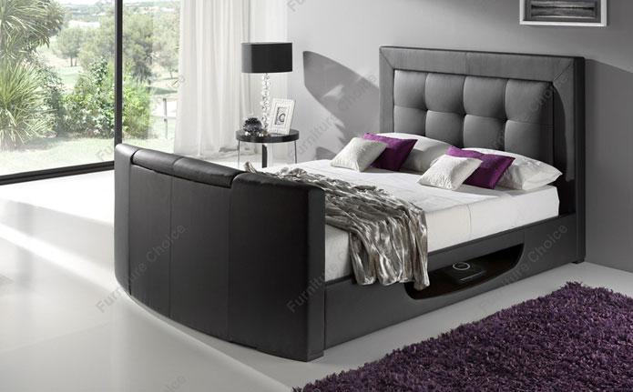 Dark bed frame with white sheets and pillows.