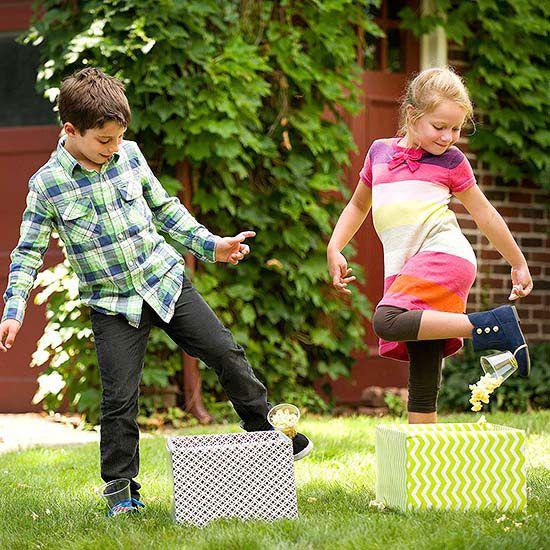 Two children playing with printed boxes.