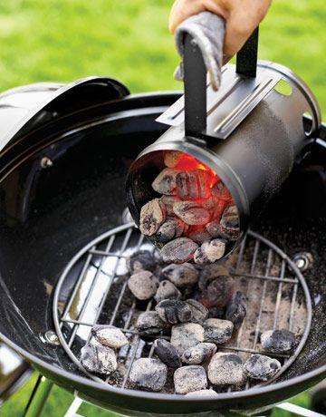 Hot coals being poured into the grill.