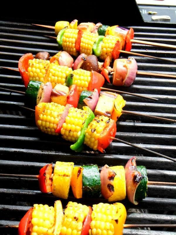 Assorted skewered vegetables on the grill.