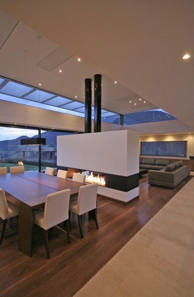 Modern fireplace that separates the dining room from the living room. 