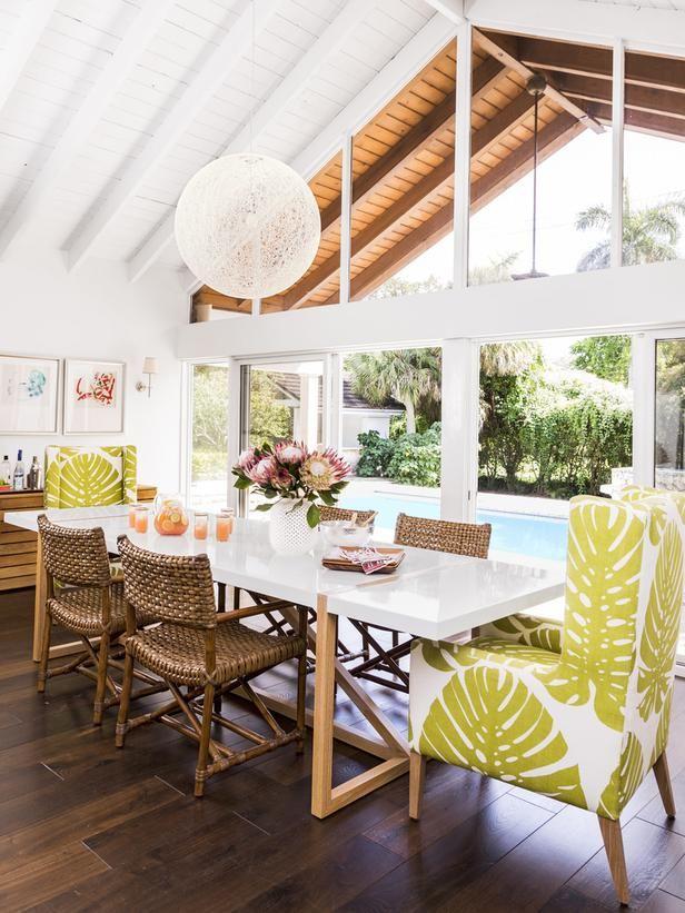 Tropical dining space with printed fabric chairs. 