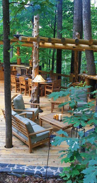 Outdoor dining area with fabric sofas around a coffee table.