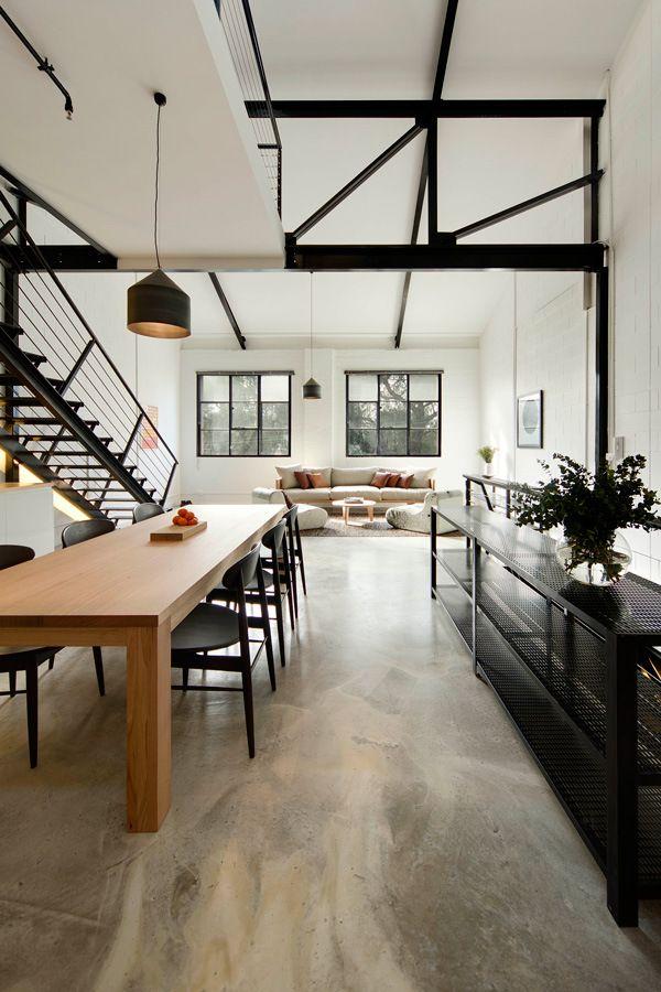 Spacious home with wooden table and bold black elements. 