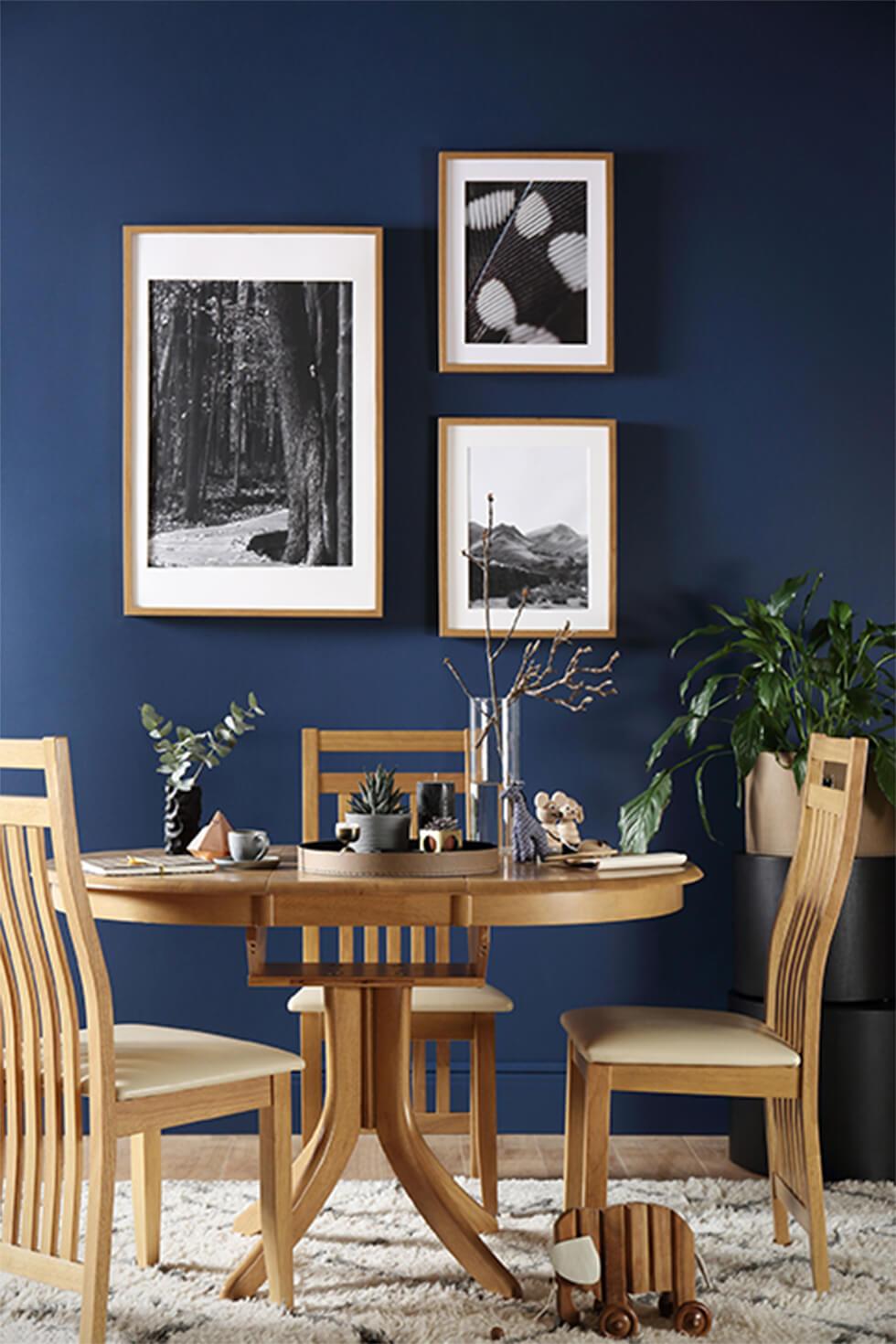 Oak dining set in dark blue dining room