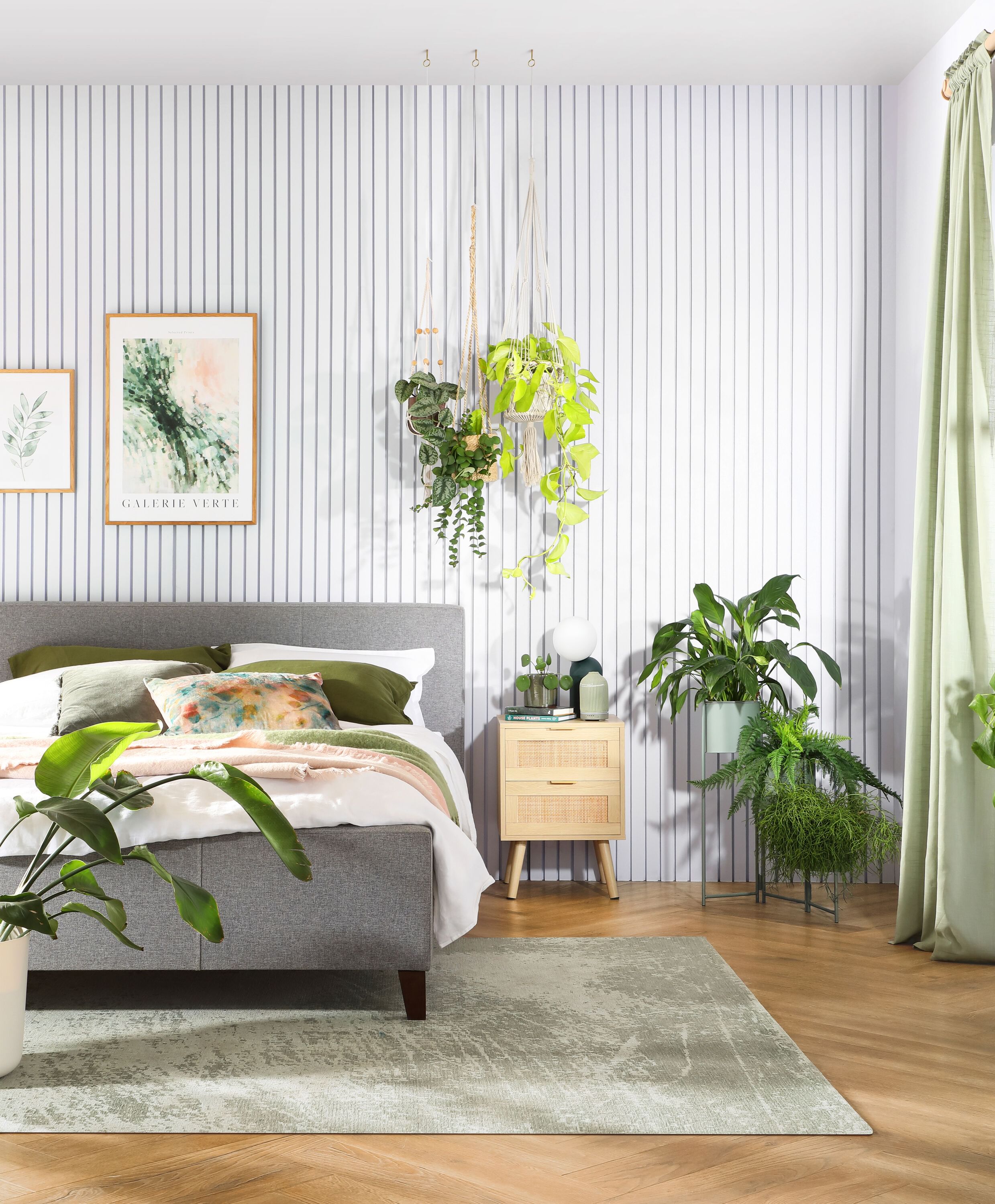 Floor to ceiling wood slats painted white in a nature inspired bedroom