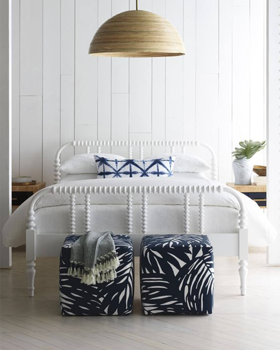 Bedroom with white wall panels and indigo patterns