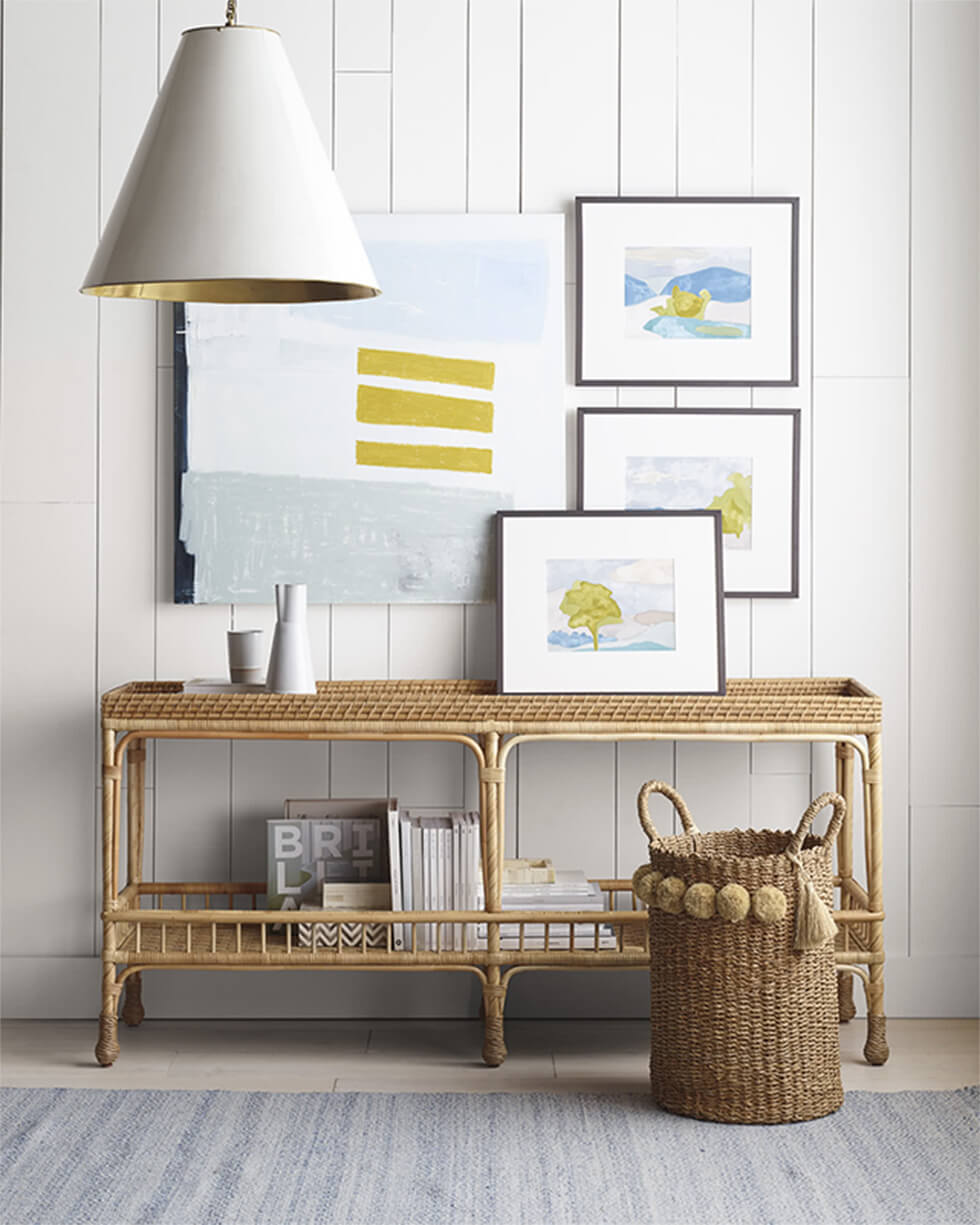 Living room with rattan sideboard and paintings