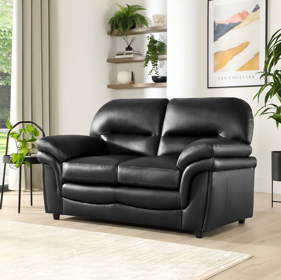 Black 2 seater sofa in timeless living room with light wood tones