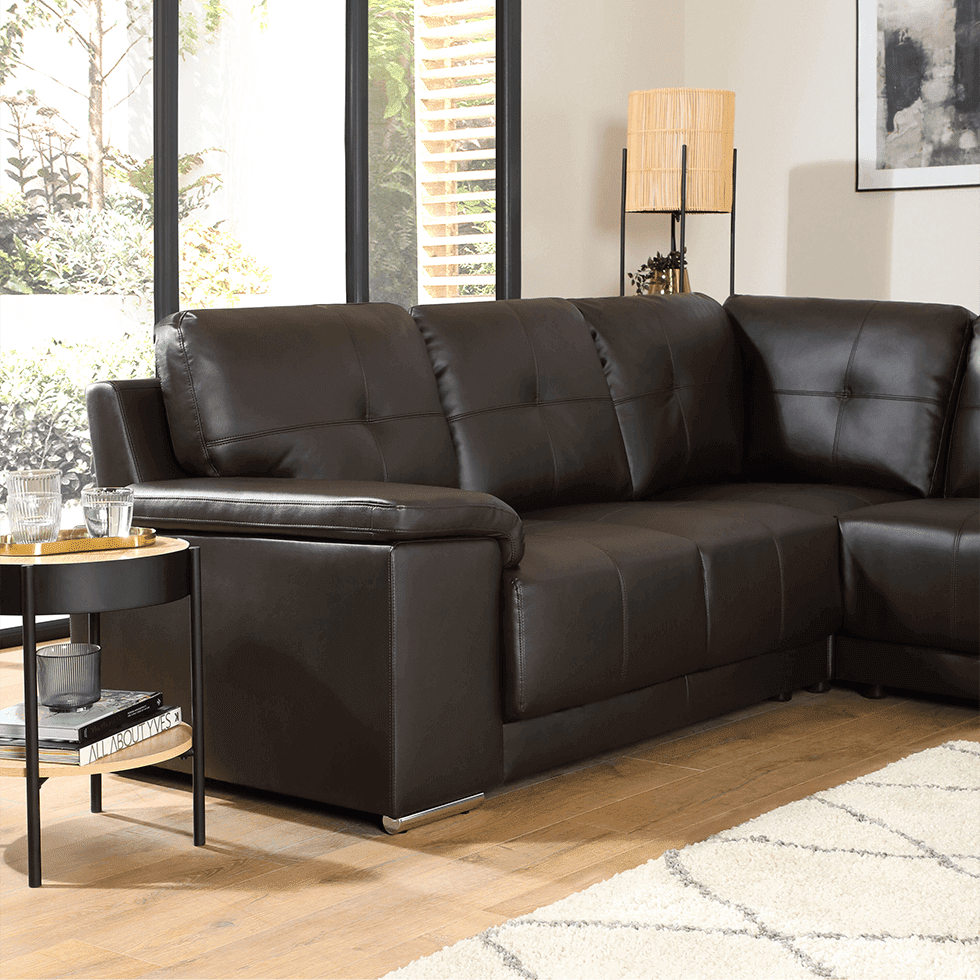 A brown leather sofa in a relaxing, neutral living room