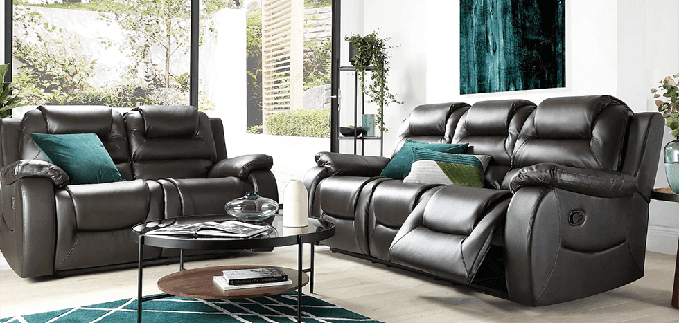 A brown leather recliner sofa set with emerald green cushions, rug and artwork
