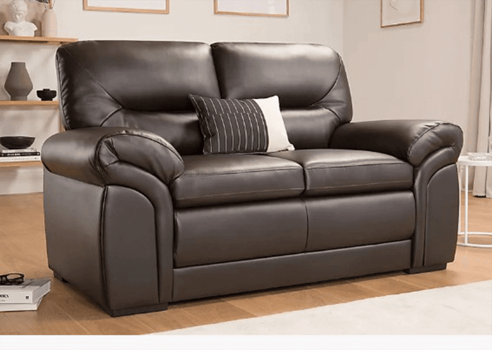 A brown leather 2 seater sofa in a living room with wood flooring