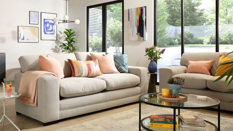 Living room with dark grey sofa and dusky pink feature wall