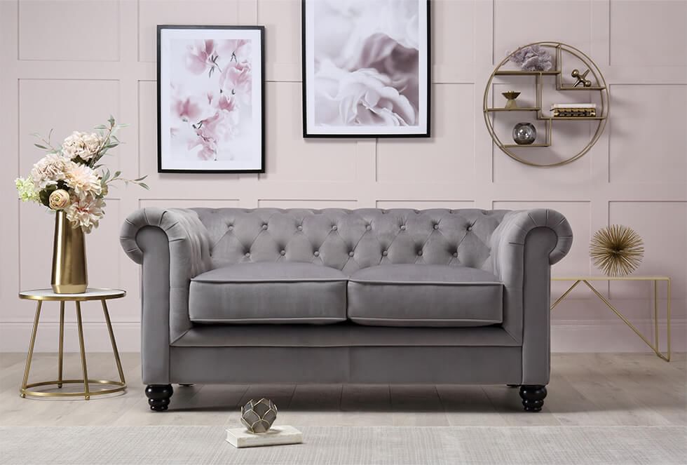 Living room with a Chesterfield grey sofa and blush pink walls