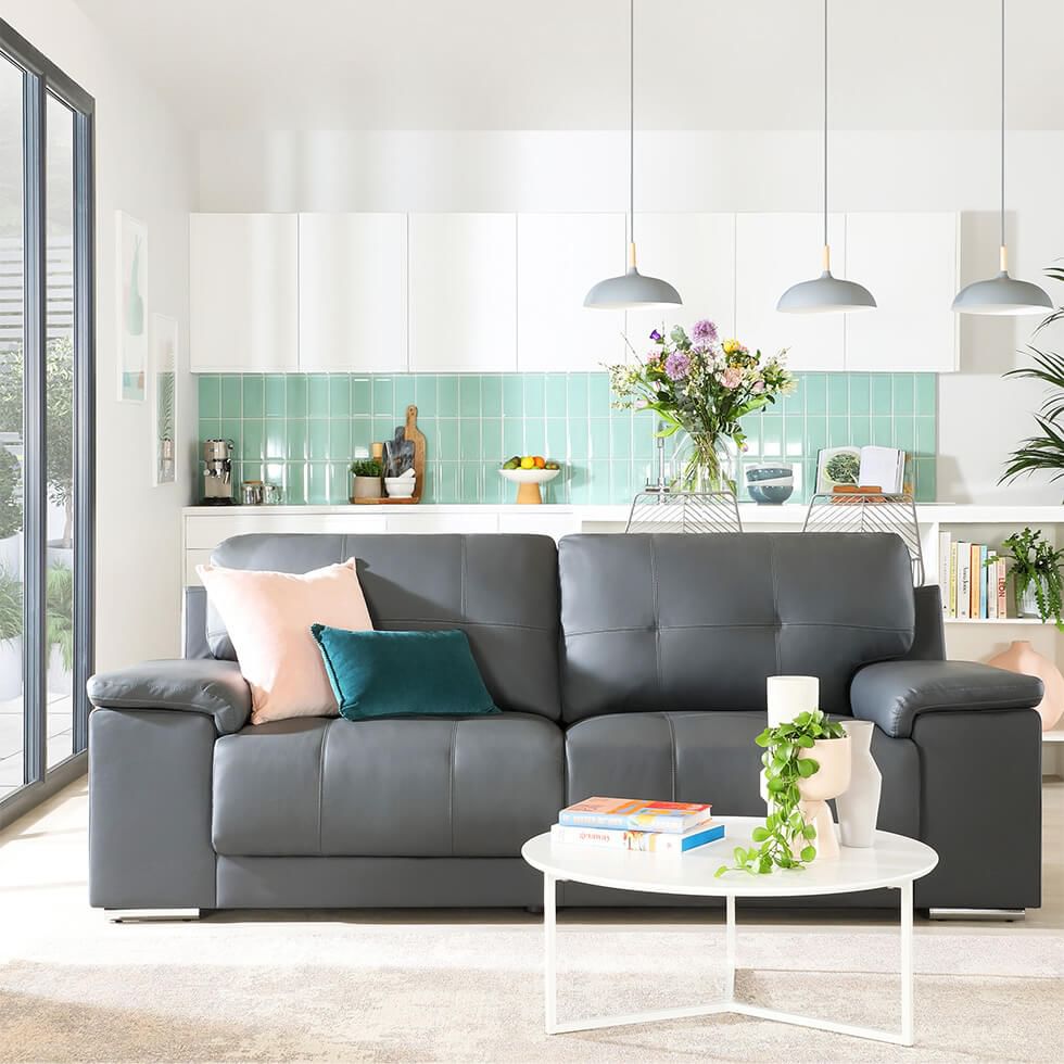 White living room with a grey sofa and sage green accents