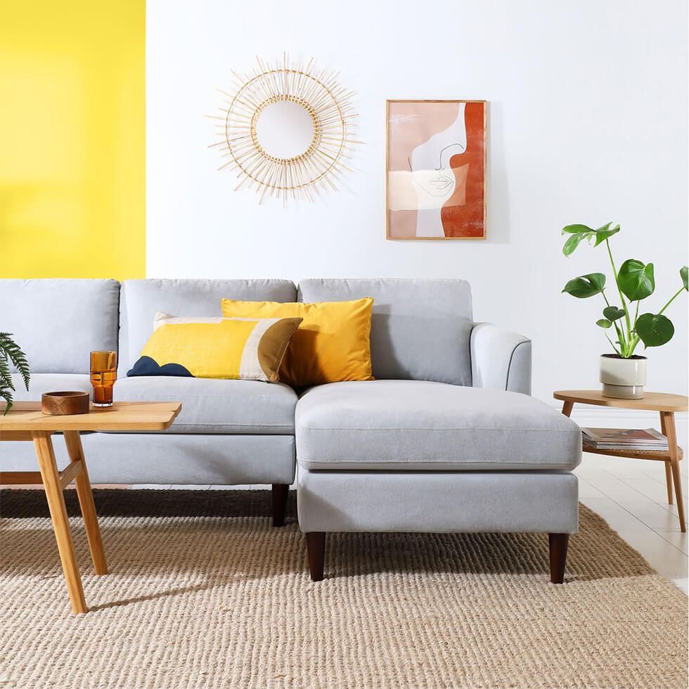 Light grey sofa and yellow feature wall