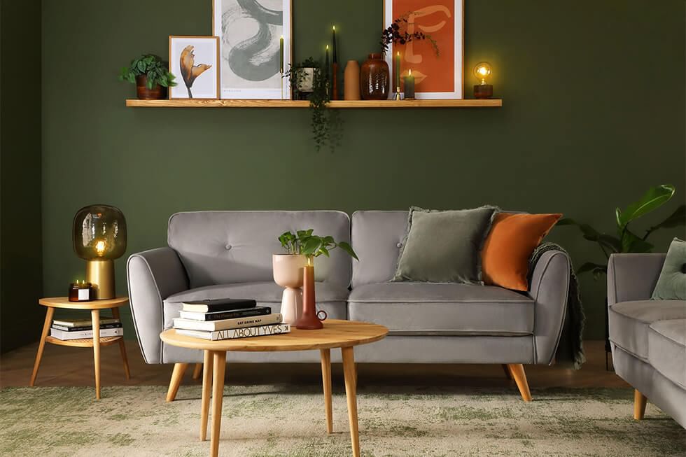 Living room with dark green walls and grey sofa