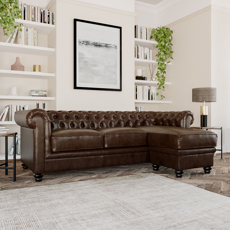 A classic dark brown leather Chesterfield sofa in an elegant, contemporary living room