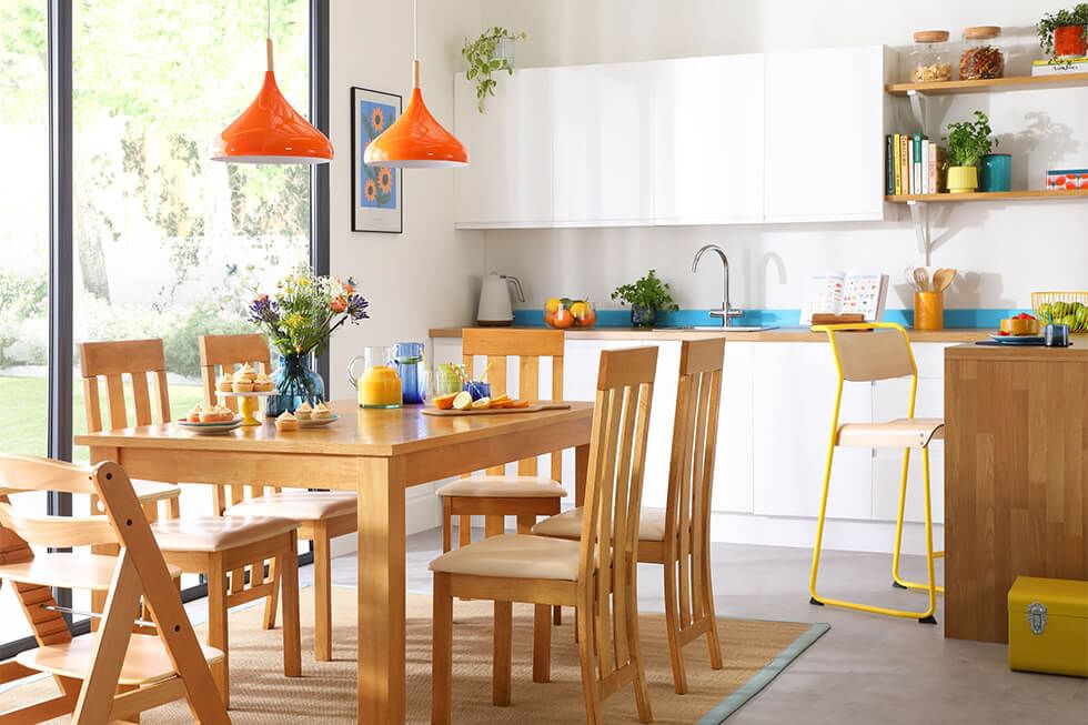 A blue, yellow and white dining room with a white dining set