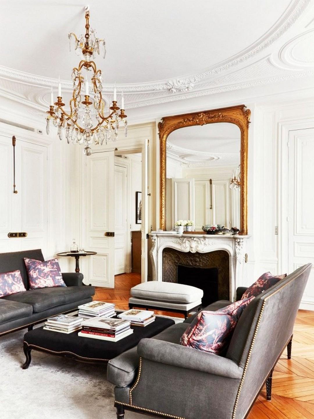 Chic parisian living room with black sofa and crystal chandelier.